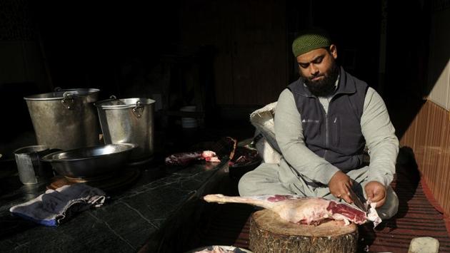 Umar Shafi Bhat, preps for  a batch of Harissa at Sultani Harissa in Fateh Kadal. Cooked overnight, service is wrapped by 10am. By then, the master cooks are usually scraping off the crust at the bottom of the pot. The crust, called phuher, is a favourite with children. Once the pot is cleaned, preparations begin for the next morning. Harissa-making is a round-the-clock job. (Waseem Andrabi / HT Photo) 