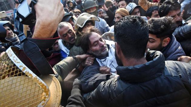 Separatist leader Yasin Malik (C) and other demonstrators scuffle with police while attempting to march to military headquarters in Srinagar against the killing of seven civilians on December 15 when security forces opened fire at a protest over the killing of three militants. Total curfew was imposed in parts of Srinagar and mobile internet suspended in some areas. (Tauseef Mustafa / AFP) Separatist leader Yasin Malik (C) and other demonstrators scuffle with police while attempting to march to military headquarters in Srinagar against the killing of seven civilians on December 15 when security forces opened fire at a protest over the killing of three militants. Total curfew was imposed in parts of Srinagar and mobile internet suspended in some areas. (Tauseef Mustafa / AFP)