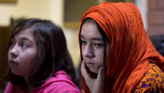 Shahnaz, 16, right, and Shakeela, 12, daughters of Mir Aman, whose Muslim Uighur wife has reportedly been taken to internment camps in China. (AP) Shahnaz, 16, right, and Shakeela, 12, daughters of Mir Aman, whose Muslim Uighur wife has reportedly been taken to internment camps in China. (AP)