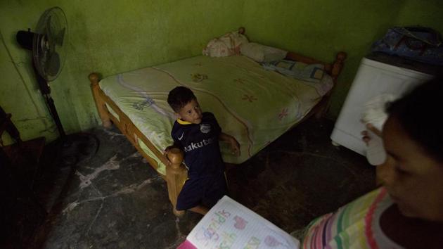 When she broached the subject a month later, her oldest, who is 10, said she could go. She promised to send enough money for them to eat pizza once a week and hopefully get Christmas presents. Her children stay with her 30-year-old brother, a nurse without children of his own, and often spend long hours with a 62-year-old neighbour whose own grandchildren have already fled. (Fernando Llano / AP) When she broached the subject a month later, her oldest, who is 10, said she could go. She promised to send enough money for them to eat pizza once a week and hopefully get Christmas presents. Her children stay with her 30-year-old brother, a nurse without children of his own, and often spend long hours with a 62-year-old neighbour whose own grandchildren have already fled. (Fernando Llano / AP)