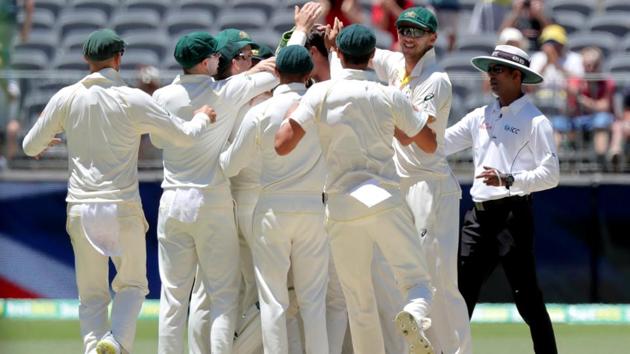Australia's players celebrate after they defeated India on day five of the second test match between Australia and India at Perth Stadium in Perth.(REUTERS)