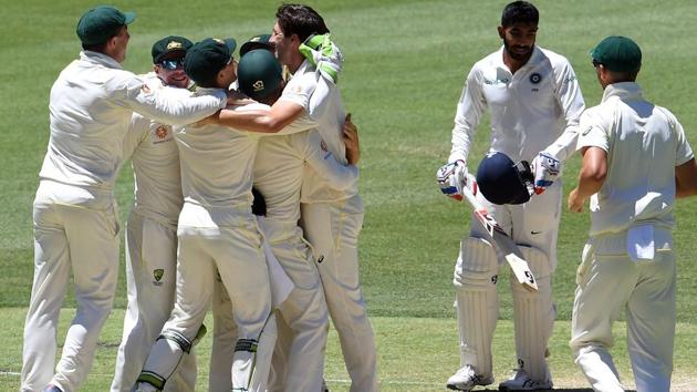 Australian players celebrate their victory as India's last batsman Jasprit Bumrah (2nd R) walks off the field during the day five of the second Test cricket match between Australia and India in Perth. (AFP)