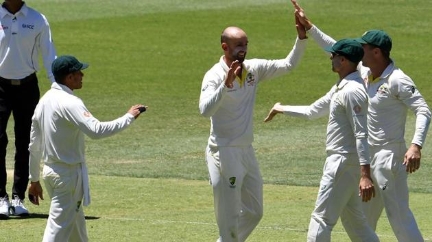 Australia's bowler Nathan Lyon (C) celebrates with teammates after dismissing India's batsman Rishabh Pant during day five of the second Test cricket match between Australia and India in Perth. (AFP)