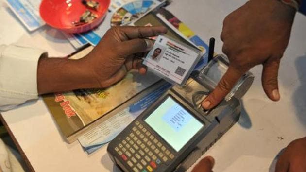 (FILES) This file photo taken on January 18, 2017 shows a man giving a thumb impression to withdraw money from his bank account with his Aadhaar.(AFP File)