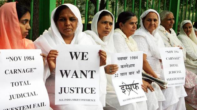 In this file photo taken on October 31, 2006 relatives of Indian Sikhs killed in the 1984 riot hold placards during a protest demanding justice in New Delhi. - An Indian court on November 20, 2018 handed down first death penalty over deadly 1984 anti-Sikh riots.(AFP)