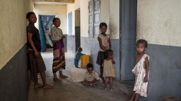 Patients stand in a corridor at the Amboasary-Sud Hospital. WFP local coordinator Mamy Razafindrakoto said the region faces a grim time until at least the next harvest in April. “Here people work, they are not lazy, they make progress when they have some water -- the problem is that there is none,” he said. They drink and wash from the same puddles as cattle. (Rijasolo / AFP) Patients stand in a corridor at the Amboasary-Sud Hospital. WFP local coordinator Mamy Razafindrakoto said the region faces a grim time until at least the next harvest in April. “Here people work, they are not lazy, they make progress when they have some water -- the problem is that there is none,” he said. They drink and wash from the same puddles as cattle. (Rijasolo / AFP)