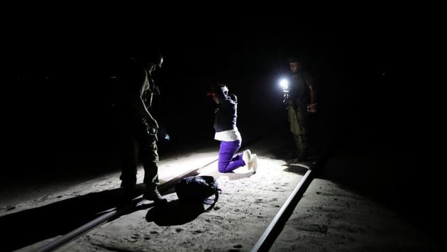 In the pitch black of the moonless Chilean desert night, the Cuban man is hard to spot until he is within yards of the border. Placing a small backpack of clothes on the ground, Yoniel Torres, 31, a father of two, puts his hands up as police approach with flashlights and take him into custody. (Ivan Alvarado / REUTERS)