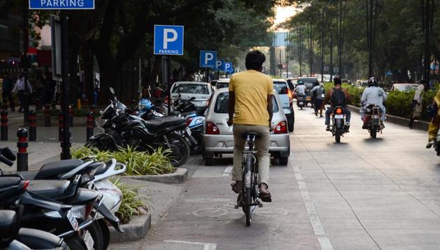 Vehicles are parked on the cycle track in Aundh. Expensive red paint used to segregate the track has worn out and cannot be seen.(Milind Saurkar/HT Photo)