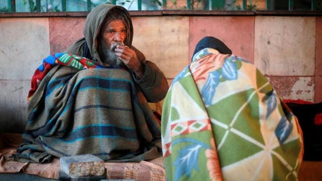 A man wrapped in a quilt drinks tea as he sits under a flyover on a cold winter morning in New Delhi on December 18. (REUTERS) A man wrapped in a quilt drinks tea as he sits under a flyover on a cold winter morning in New Delhi on December 18. (REUTERS)