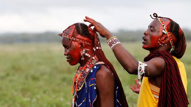A Maasai Moran athlete has his hair smeared with red ochre paint, a mixture of butterfat and red pigment that has been ground from earth containing a high iron ore content, during preparations for the 2018 Maasai Olympics. (Thomas Mukoya) A Maasai Moran athlete has his hair smeared with red ochre paint, a mixture of butterfat and red pigment that has been ground from earth containing a high iron ore content, during preparations for the 2018 Maasai Olympics. (Thomas Mukoya)