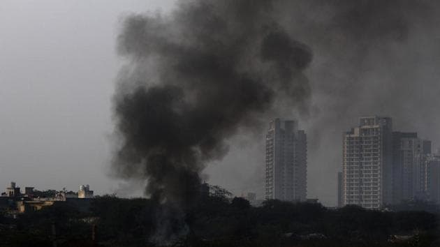 Heaps of garbage seen burning in an open field in Bajgehra near Dwarka Expressway, in Gurugram on December 7.(Yogendra Kumar/HT PHOTO)