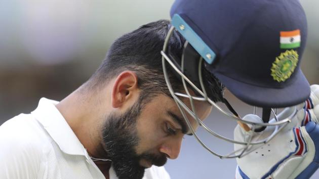 India's Virat Kohli removes his helmet as he walks off after being dismissed during play in the second cricket test between Australia and India in Perth, Australia, Monday, Dec. 17, 2018. (AP Photo/Trevor Collens)(AP)