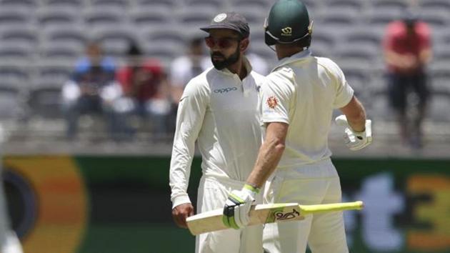 India's Virat Kohli, centre, looks to the umpire after he and opposing captain, Australia's Tim Paine came face to face in Perth.(AP) India's Virat Kohli, centre, looks to the umpire after he and opposing captain, Australia's Tim Paine came face to face in Perth.(AP)