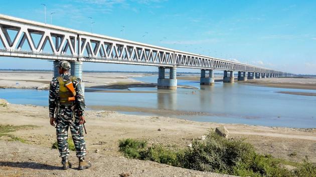A security personnel stands guard at Bogibell Bridge in Dibrugarh. Prime Minister Narendra Modi will inaugurate on December 25 the Bogibeel Bridge, India's longest rail-road bridge, connecting the north and south banks of the Brahmaputra, falling in the eastern part of Assam and Arunachal Pradesh.(PTI)