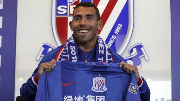 File image of Argentine footballer Carlos Tevez posing with the Shanghai Shenhua jersey. (AFP) File image of Argentine footballer Carlos Tevez posing with the Shanghai Shenhua jersey. (AFP)
