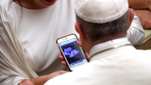 Pope Francis blesses a pregnant woman’s ultrasound during the weekly general audience at Paul VI hall at the Vatican. (Max Rossi / REUTERS) 