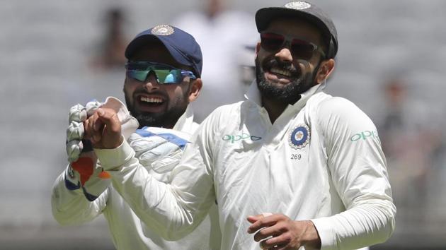 Rishabh Pant, left, and Virat Kohli share a laugh amid an Australian batting collapse during play in the second Test.(AP) Rishabh Pant, left, and Virat Kohli share a laugh amid an Australian batting collapse during play in the second Test.(AP)
