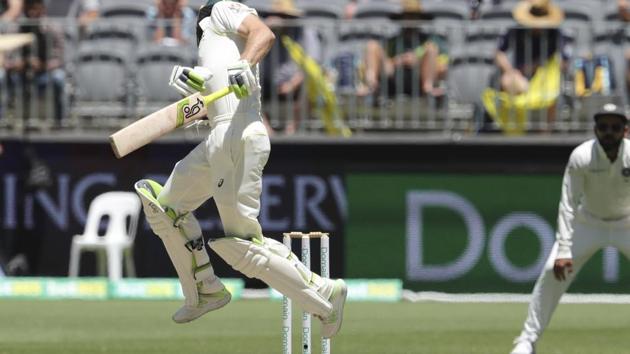 Australia's Tim Paine gets tangled up trying to fend off a short ball from India's Mohammed Shami during play in the second cricket test between Australia and India in Perth.(AP)