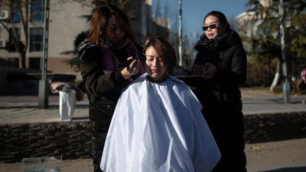 Li Wenzu has her head shaved to protest the detention of her husband and Chinese human rights lawyer Wang Quanzhang, detained during the 709 crackdown, in Beijing, China. (Fred Dufour / AFP) 