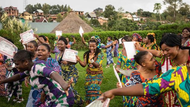Students sing and dance after receiving their certificates during their graduation party from the City of Joy in Bukavu, Democratic Republic of Congo. (Fredrik Lerneryd / AFP) 