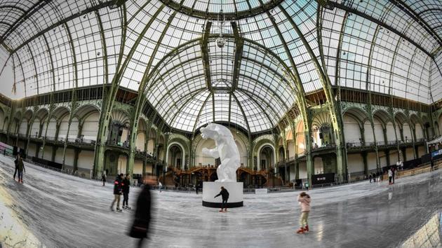 A general view of people on the ice skating rink hosted at the glass-roofed central hall of the Grand Palais in Paris, France. (Stephanie De Sakutin / AFP) 