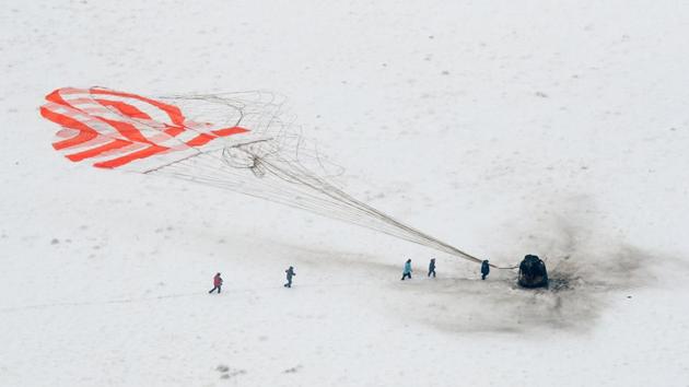 A search and rescue team approaches the Soyuz MS-09 capsule carrying the International Space Station (ISS) crew of NASA astronaut Serena Aunon-Chancellor, Alexander Gerst of the European Space Agency and Russian cosmonaut Sergey Prokopyev after its landing outside the town of Dzhezkazgan, Kazakhstan following a troubled stint on the ISS marred by an air leak and the failure of a rocket set to bring new crew members. (Shamil Zhumatov / AFP) 