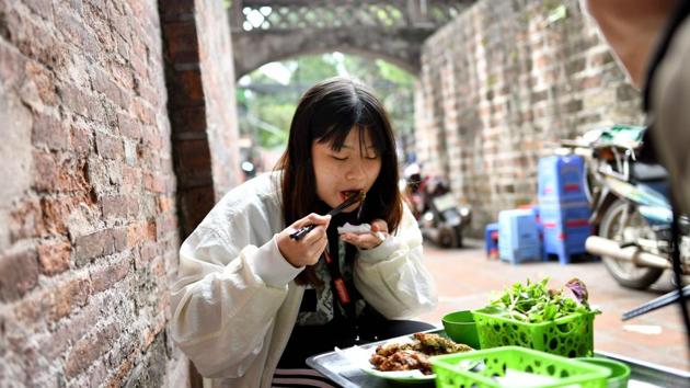 A patron digs into piping hot ‘cha ruoi’ fritters. Though Vietnamese cuisine is best known outside its borders for “pho” noodle soup and “banh mi” pate baguettes, winter fritters are not the only dishes to feature creepy crawlers. (Manan Vatsyayana / AFP) A patron digs into piping hot ‘cha ruoi’ fritters. Though Vietnamese cuisine is best known outside its borders for “pho” noodle soup and “banh mi” pate baguettes, winter fritters are not the only dishes to feature creepy crawlers. (Manan Vatsyayana / AFP)