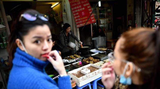 Vietnamese women wait outside a stall selling ‘cha ruoi’ ragworms fritters. The worms can also be stewed in a sticky caramel sauce, stirred with herbs or mixed with chillies to make a spicy condiment. But ragworm fritters -- best prepared while the wriggling worms are still alive -- have long been a favourite. (Manan Vatsyayana / AFP) Vietnamese women wait outside a stall selling ‘cha ruoi’ ragworms fritters. The worms can also be stewed in a sticky caramel sauce, stirred with herbs or mixed with chillies to make a spicy condiment. But ragworm fritters -- best prepared while the wriggling worms are still alive -- have long been a favourite. (Manan Vatsyayana / AFP)