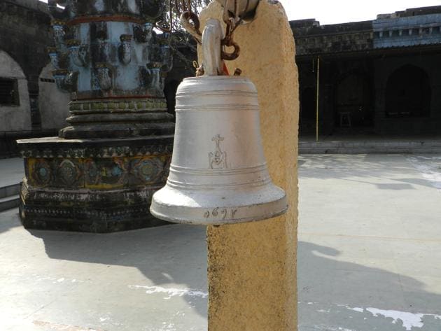 A bell at the Nimgaon Khandoba temple in Pune district with a crucifix on it.