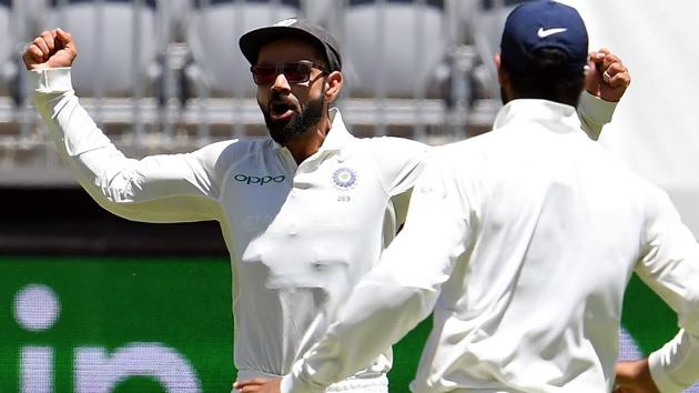 India's captain Virat Kohli (L) celebrates the dismissal of Australia's batsman Usman Khawaja.(AFP)