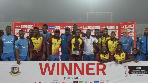 West Indies cricketers pose with the tournament trophy following the third Twenty20 (T20) cricket match between Bangladesh and West Indies at the Sher-e-Bangla National Cricket Stadium in Dhaka on December 22, 2018. (AFP) West Indies cricketers pose with the tournament trophy following the third Twenty20 (T20) cricket match between Bangladesh and West Indies at the Sher-e-Bangla National Cricket Stadium in Dhaka on December 22, 2018. (AFP)