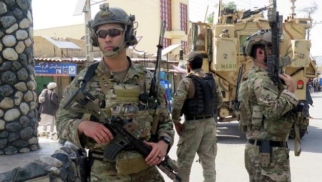 US troops keep watch during an official visit in Farah province, Afghanistan on May 19.(REUTERS)