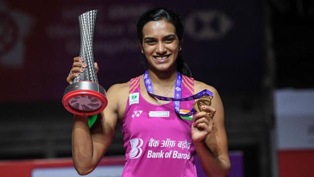 PV Sindhu poses with her trophy after the women’s singles final match at the 2018 BWF World Tour Finals badminton competition in Guangzhou in southern China’s Guangdong province. (Stringer / AFP)