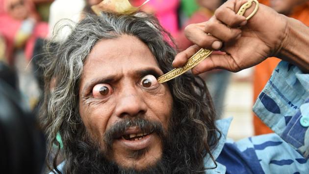 A man goes in to pierce his eye while participating in a ‘Rafai Silsila’ during the commemoration of the 9th Urs or death anniversary of the Rafai Papa Miyan Sai at the Shah-E-Alam Dargah shrine in Ahmedabad, Gujarat. (Sam Panthaky / AFP)