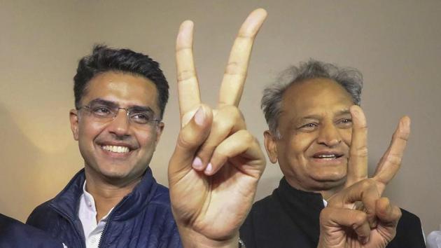 Congress leaders Ashok Gehlot (R) and Sachin Pilot (C) flash victory signs after the declaration of Rajasthan Assembly election result in Jaipur.(PTI Photo)