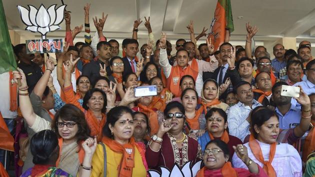 Gandhinagar: Gujarat Chief Minister Vijay Rupani with wife Anjali and BJP supporters celebrate the win of BJP leader Kunvarji Bavaliya in Jasdan Assembly bypolls, in Gandhinagar, Sunday, Dec. 23, 2018. (PTI Photo)(PTI)