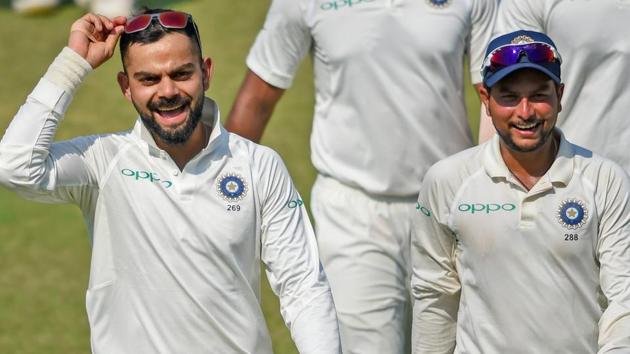 Virat Kohli and team player Kuldeep Yadav celebrate their victory in the first Test match, in Rajkot. (PTI) Virat Kohli and team player Kuldeep Yadav celebrate their victory in the first Test match, in Rajkot. (PTI)