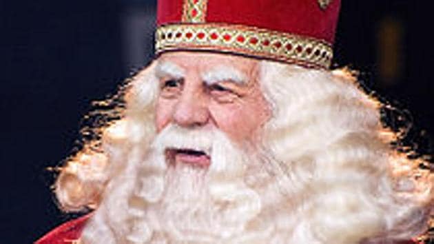 Nicholas the Bishop, famous for his good work among the poor, was cannonised in the first millennium. By the 13th century, he was a beloved figure in The Netherlands. There, St Nicholas, over time, became Sinterklaas. To this day, the official Dutch Sinterklaas (above) is a trim, bishop-ly figure in a white robe and red cape, with almost-regal long white hair and beard. He travels, incidentally, by white horse.