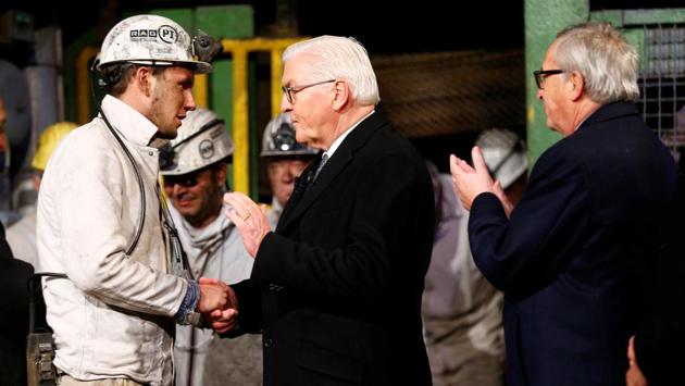 A miner shakes hands with German President Frank-Walter Steinmeier as European Commission President Jean-Claude Juncker claps during a ceremony marking the end of an industry that laid the foundations for Germany’s industrial revolution and its post-war economic recovery. “A piece of German history is coming to an end here,” Steinmeier told the miners. (Wolfgang Rattay / REUTERS) A miner shakes hands with German President Frank-Walter Steinmeier as European Commission President Jean-Claude Juncker claps during a ceremony marking the end of an industry that laid the foundations for Germany’s industrial revolution and its post-war economic recovery. “A piece of German history is coming to an end here,” Steinmeier told the miners. (Wolfgang Rattay / REUTERS)