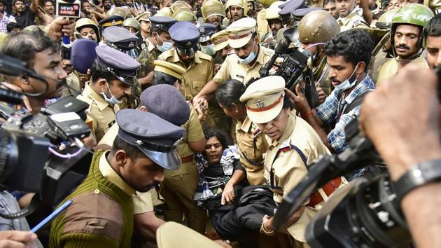 Two women of menstruating age started trekking to Sabarimala early morning today despite strong protest from devotees. Hours after they began the trek, they were brought back to Pamba base camp. Kerala has witnessed massive protests by devotees and the BJP opposing the apex court verdict of September 28 permitting women of all age groups into the shrine. (AFP) Two women of menstruating age started trekking to Sabarimala early morning today despite strong protest from devotees. Hours after they began the trek, they were brought back to Pamba base camp. Kerala has witnessed massive protests by devotees and the BJP opposing the apex court verdict of September 28 permitting women of all age groups into the shrine. (AFP)