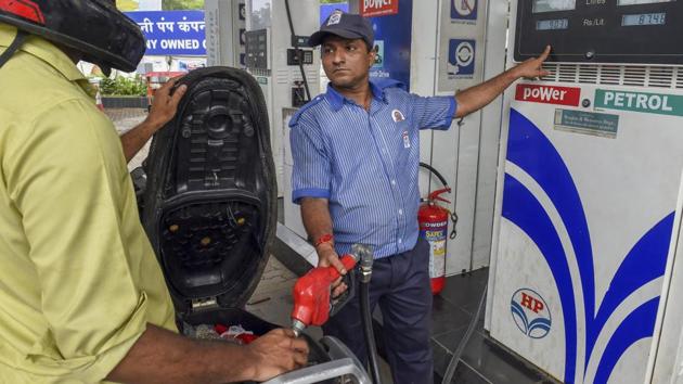 An employee shows the revised prices of petrol and diesel to a customer at a fuel station in Mumbai (PTI File Photo) An employee shows the revised prices of petrol and diesel to a customer at a fuel station in Mumbai (PTI File Photo)
