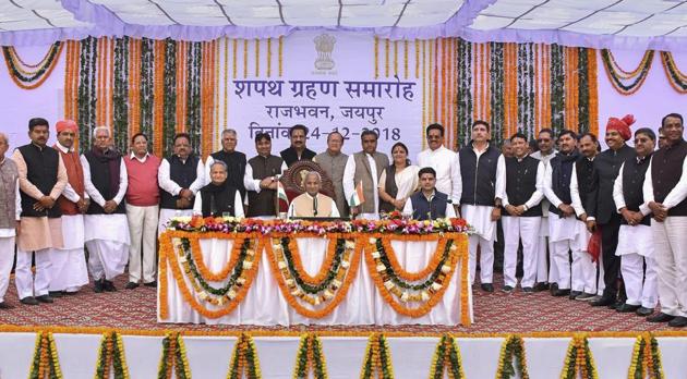 Rajasthan governor Kalyan Singh, chief minister Ashok Gehlot, deputy chief minister Sachin Pilot pose for a photograph with the newly sworn-in cabinet ministers during a ceremony at Raj Bhawan, in Jaipur, Monday, Dec. 24, 2018.(PTI)