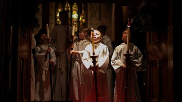 Children extinguish candles after carrying them during the recessional during a Christmas Eve service at Grace Episcopal Church in Nyack, New York. (Mike Segar / REUTERS) Children extinguish candles after carrying them during the recessional during a Christmas Eve service at Grace Episcopal Church in Nyack, New York. (Mike Segar / REUTERS)