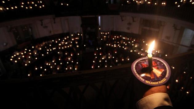 Christians hold candles as they attend a mass on Christmas Eve at Immanuel Church in Jakarta, Indonesia. The Christmas holiday in Indonesia is sombre this year, with prayers for the tsunami victims who were hit by waves that struck without warning on Saturday. Church leaders called on Christians across the country to pray for victims of the tsunami. (Dhemas Reviyanto/ Antara Foto / REUTERS) Christians hold candles as they attend a mass on Christmas Eve at Immanuel Church in Jakarta, Indonesia. The Christmas holiday in Indonesia is sombre this year, with prayers for the tsunami victims who were hit by waves that struck without warning on Saturday. Church leaders called on Christians across the country to pray for victims of the tsunami. (Dhemas Reviyanto/ Antara Foto / REUTERS)