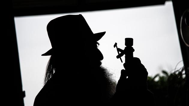 Collino with a toy is silhouetted as he works in his workshop. Every toy comes with a story or fairytale in Italian or Piedmontese, the Romance language of his region. Some are set to the strains of a home-made barrel organ, with a monkey wrench serving as a handle. (Marco Bertorello / AFP) Collino with a toy is silhouetted as he works in his workshop. Every toy comes with a story or fairytale in Italian or Piedmontese, the Romance language of his region. Some are set to the strains of a home-made barrel organ, with a monkey wrench serving as a handle. (Marco Bertorello / AFP)