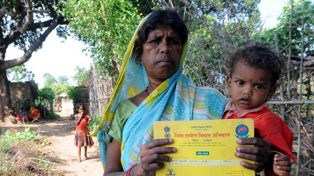 Laccho Devi showing her job card for beneficiary of The Mahatma Gandhi National Rural Employment Guarantee Act (MGNREGA) (Photo by Parwaz Khan/ Hindustan Times)(Hindustan Times)