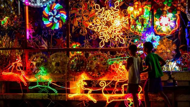 Children walk past Christmas lanterns known locally as ‘parol’ along a street in Manila, Philippines. The star-shaped lanterns patterned to resemble the Star of Bethlehem are made from bamboo covered with paper. They are displayed in houses, offices, buildings, and streets, and according to Filipino tradition, represent the victory of light over darkness. (Maria Tan / AFP) Children walk past Christmas lanterns known locally as ‘parol’ along a street in Manila, Philippines. The star-shaped lanterns patterned to resemble the Star of Bethlehem are made from bamboo covered with paper. They are displayed in houses, offices, buildings, and streets, and according to Filipino tradition, represent the victory of light over darkness. (Maria Tan / AFP)