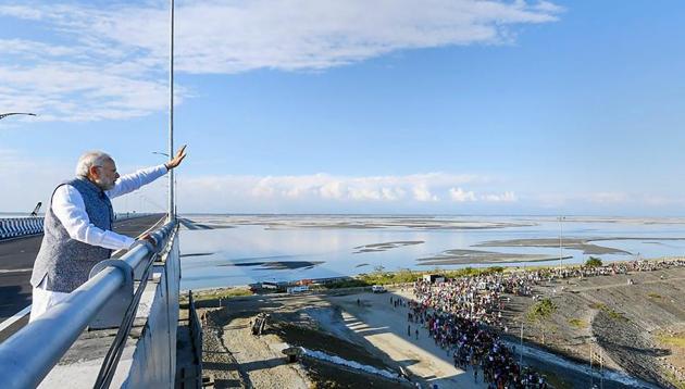 Prime Minister Narendra Modi waves at people from the Bogibeel Bridge, the longest rail-cum-road bridge on Brahmaputra river, after it was inaugurated by him, in Dibrugarh, Tuesday, Dec. 25, 2018. PM Modi also flagged off two new Intercity Express trains connecting Tinsukia and Naharlagun via the Bogibeel Bridge.(PTI)