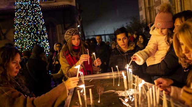 Worshippers light candles as they attend Christmas Mass at the Saint Antuan Church in Istanbul, Turkey on Christmas Eve. (Yasin Akgul / AFP) Worshippers light candles as they attend Christmas Mass at the Saint Antuan Church in Istanbul, Turkey on Christmas Eve. (Yasin Akgul / AFP)