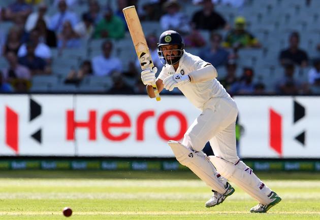 India's batsman Cheteshwar Pujara plays a shot during day one of the third cricket Test match between Australia and India in Melbourne. (AFP)